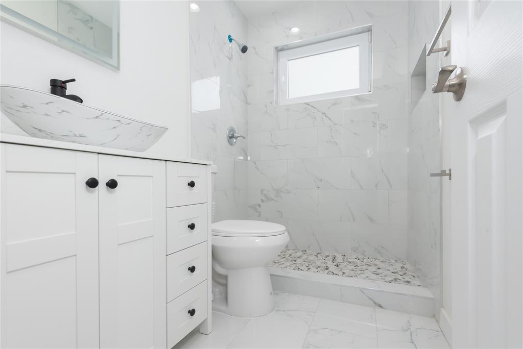 713 Southwest 4th Court Hallandale Beach, FL 33009 - Photo 19 of 38 a bathroom with a sink toilet and shower