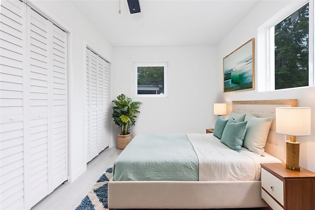 713 Southwest 4th Court Hallandale Beach, FL 33009 - Photo 2 of 38 a bedroom with a bed and window