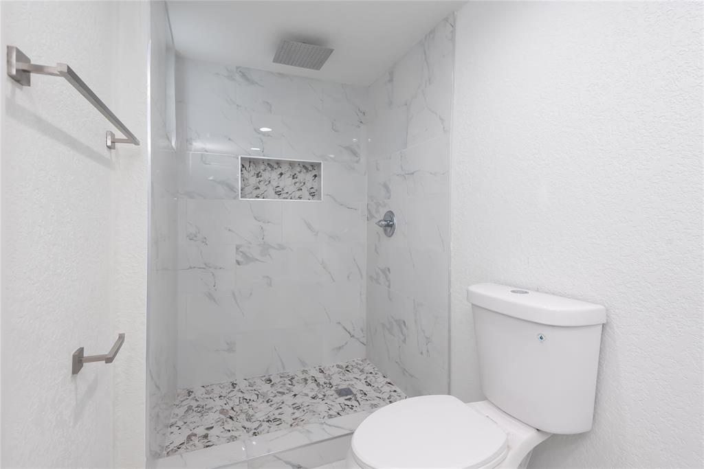 713 Southwest 4th Court Hallandale Beach, FL 33009 - Photo 23 of 38 a bathroom with a toilet and a shower