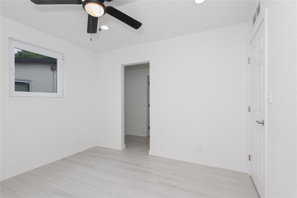 713 Southwest 4th Court Hallandale Beach, FL 33009 - Photo 24 of 38 an empty room with a ceiling fan and a window