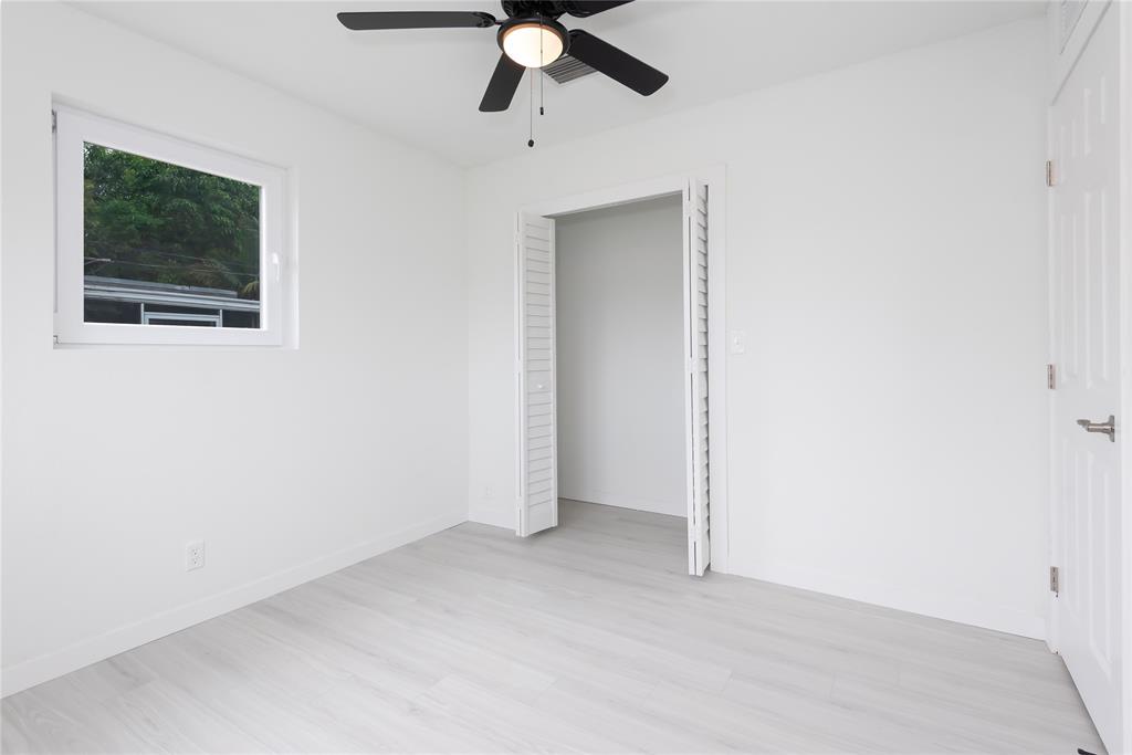 713 Southwest 4th Court Hallandale Beach, FL 33009 - Photo 25 of 38 an empty room with a window and a fan