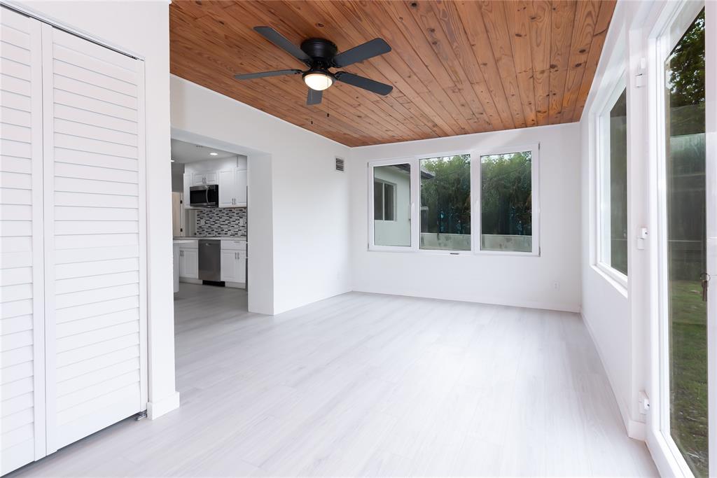 713 Southwest 4th Court Hallandale Beach, FL 33009 - Photo 28 of 38 an empty room with a ceiling fan and a rug