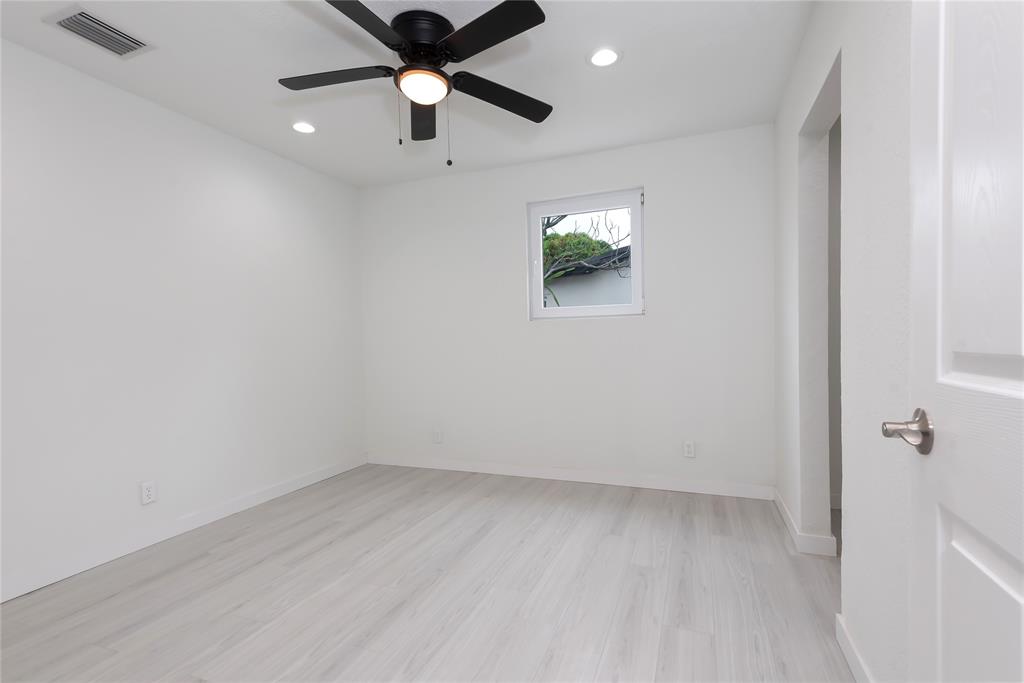 713 Southwest 4th Court Hallandale Beach, FL 33009 - Photo 30 of 38 an empty room with a ceiling fan and a window