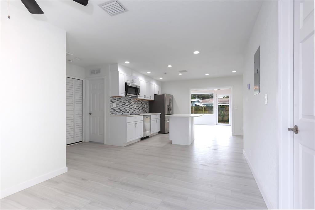 713 Southwest 4th Court Hallandale Beach, FL 33009 - Photo 33 of 38 a view of kitchen with kitchen island a sink stainless steel appliances and cabinets