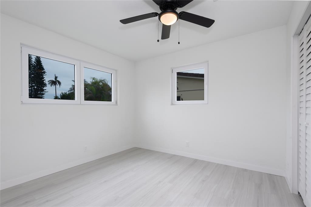 713 Southwest 4th Court Hallandale Beach, FL 33009 - Photo 35 of 38 an empty room with a window and a ceiling fan
