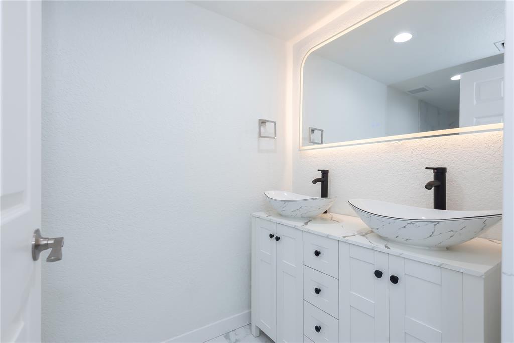 713 Southwest 4th Court Hallandale Beach, FL 33009 - Photo 36 of 38 a bathroom with a granite countertop sink and a mirror