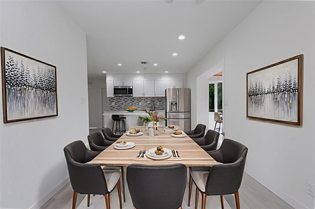 713 Southwest 4th Court Hallandale Beach, FL 33009 - Photo 5 of 38 a view of a dining room with furniture a rug and kitchen view