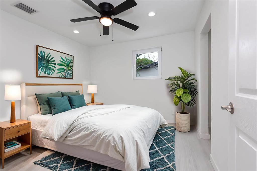 713 Southwest 4th Court Hallandale Beach, FL 33009 - Photo 6 of 38 a bedroom with a bed and a potted plant