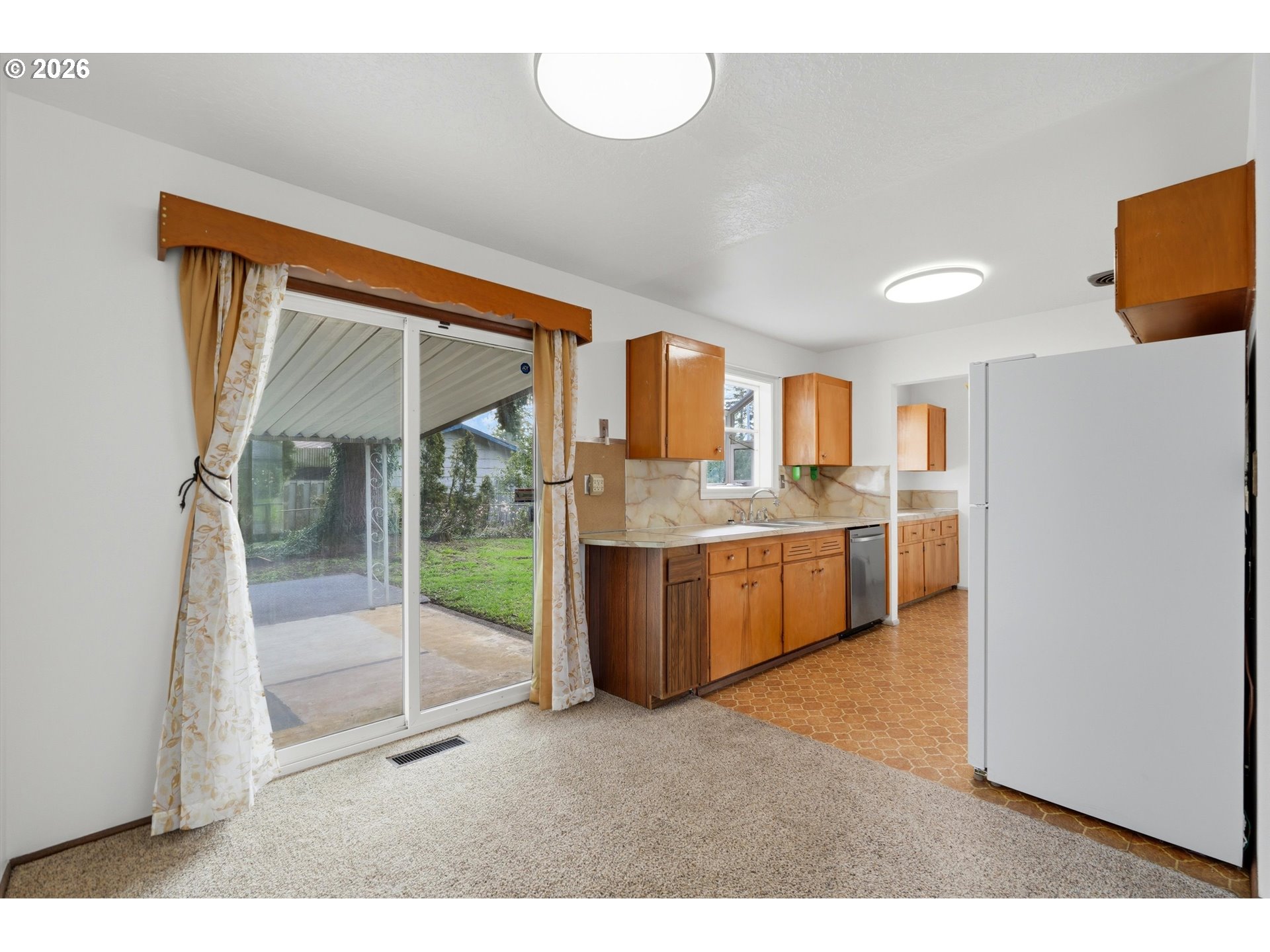 16706 Southeast Ankeny Street Portland, OR 97233 - Photo 14 of 43 a kitchen with stainless steel appliances a refrigerator and a stove