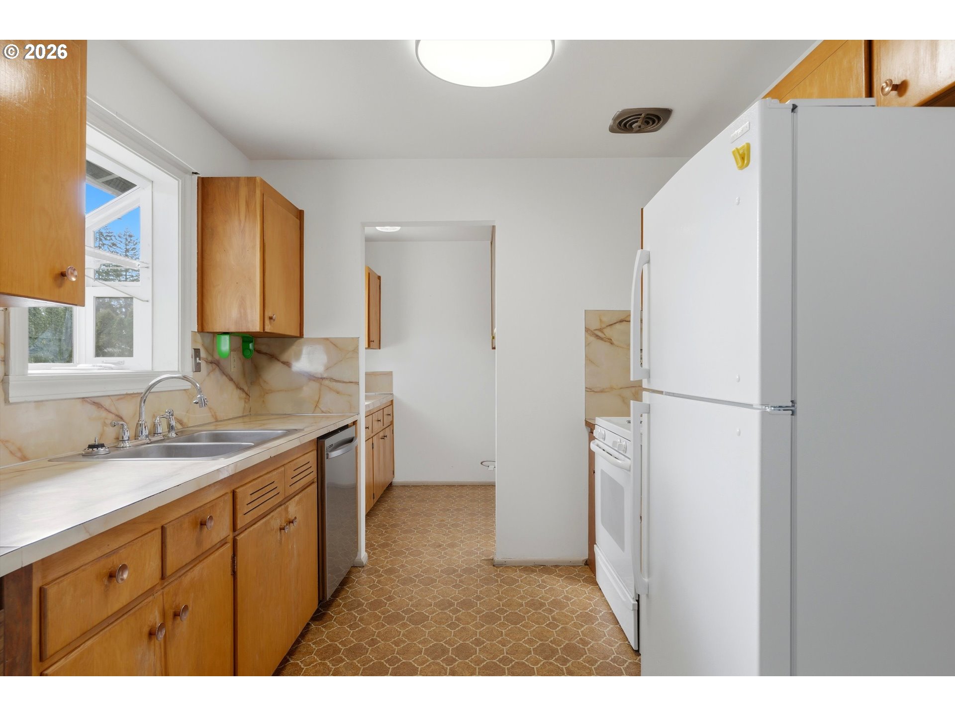 16706 Southeast Ankeny Street Portland, OR 97233 - Photo 17 of 43 a kitchen with a refrigerator and a sink