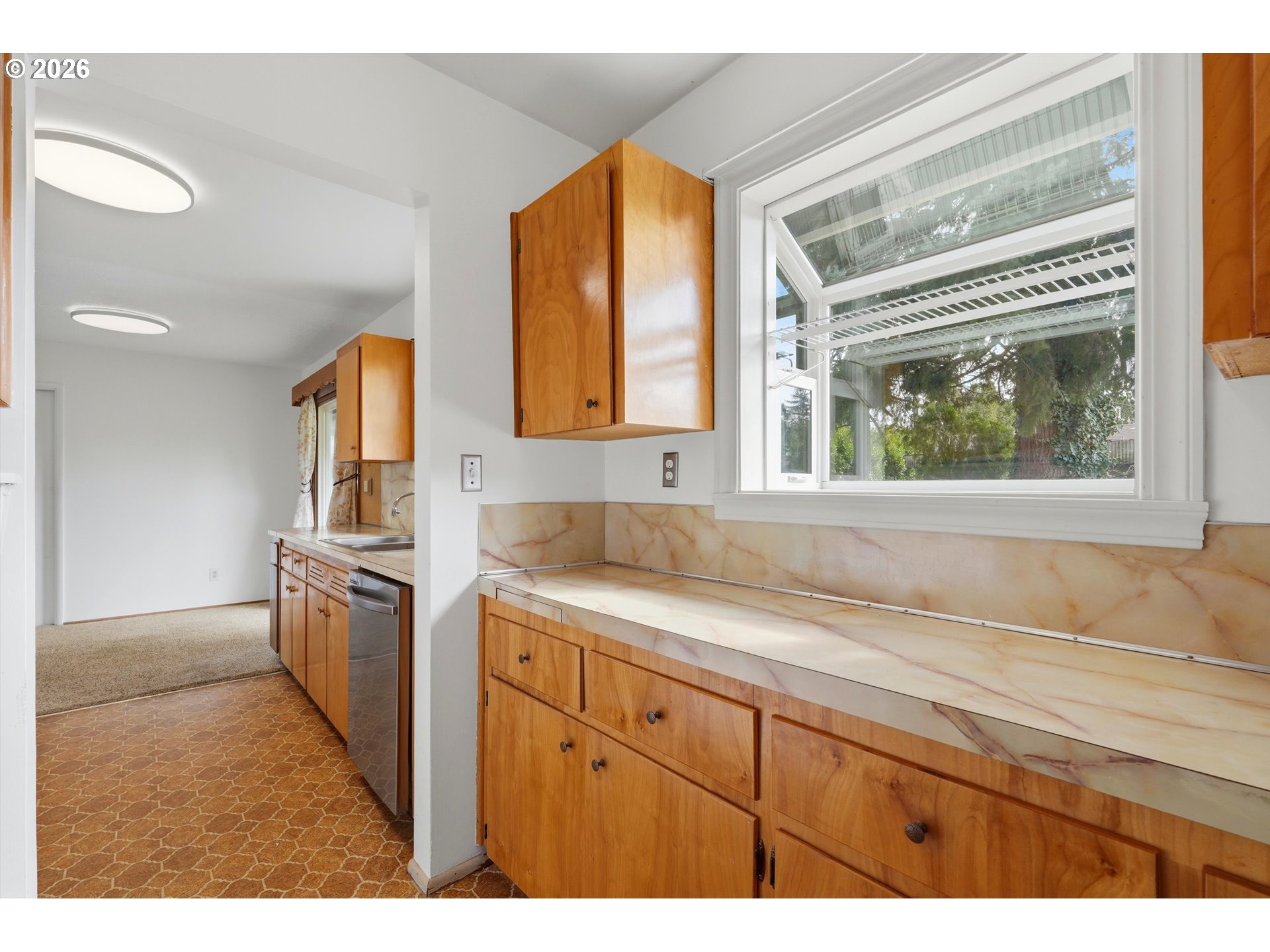 16706 Southeast Ankeny Street Portland, OR 97233 - Photo 19 of 43 a kitchen with a stove a sink and a window