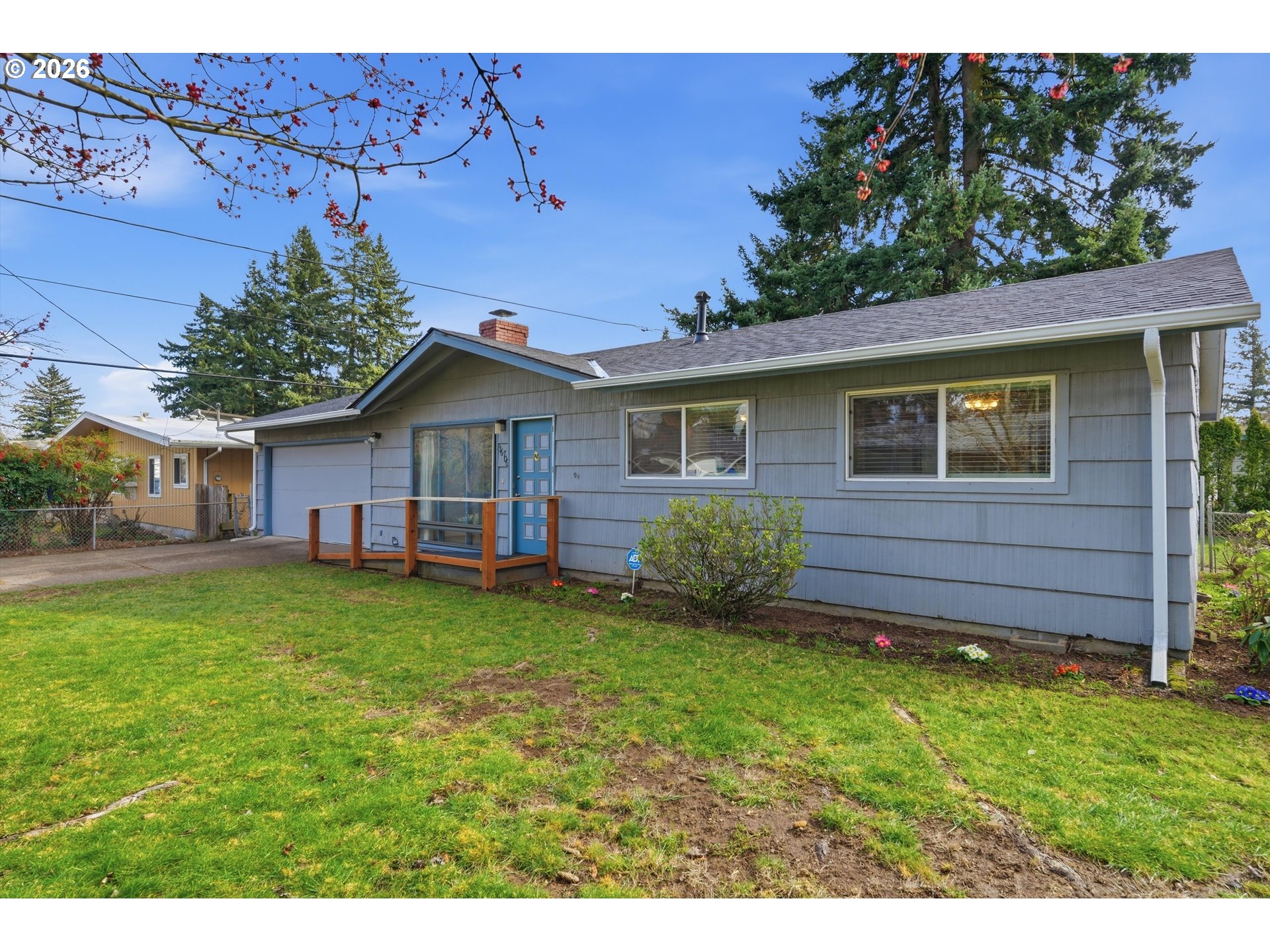 16706 Southeast Ankeny Street Portland, OR 97233 - Photo 3 of 43 a backyard of a house with wooden fence and large trees