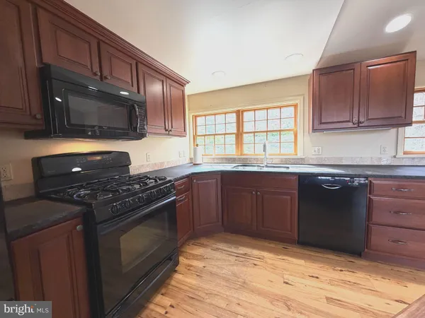 a view of an empty room and wooden floor