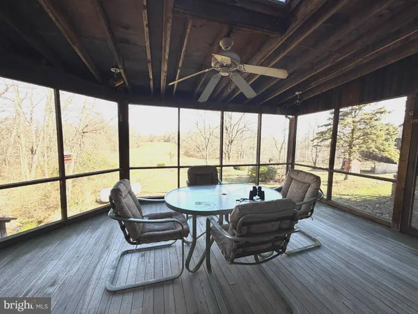 a view of empty room with wooden floor and fireplace