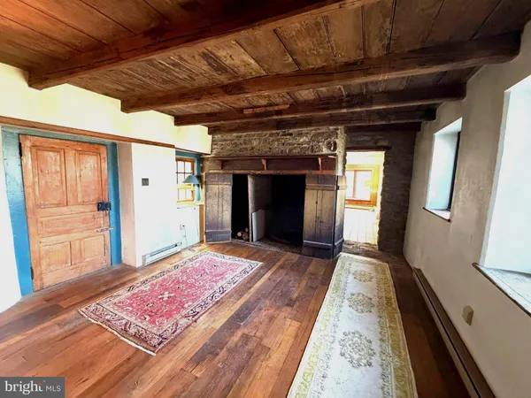 a view of an empty room and wooden floor