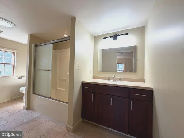 a utility room with dryer washer and stair