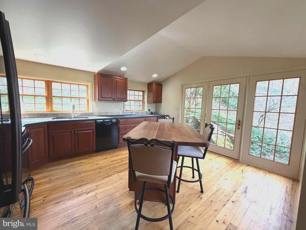 a dining room with furniture window and wooden floor