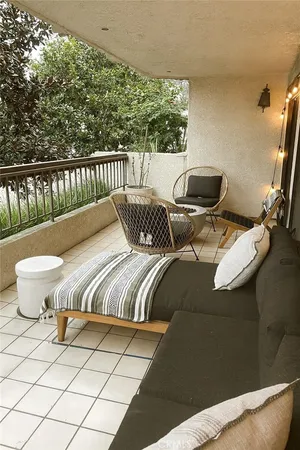 a balcony with chairs and wooden floor