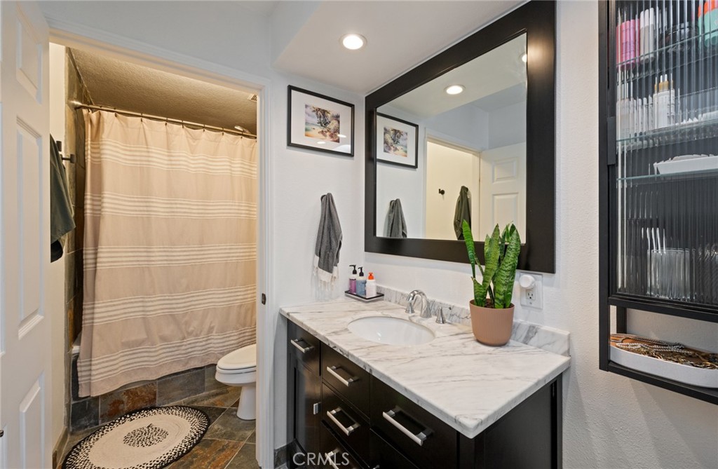 8512 Tuscany Avenue, Unit 222 Playa del Rey, CA 90293 - Photo 14 of 24 a bathroom with a granite countertop sink and a mirror