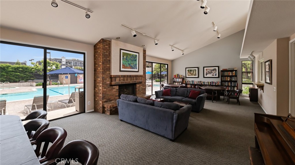 8512 Tuscany Avenue, Unit 222 Playa del Rey, CA 90293 - Photo 20 of 24 a living room with furniture two large windows and a fireplace