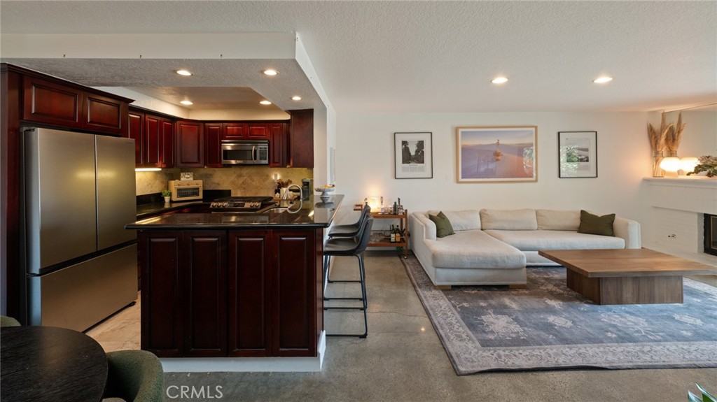 8512 Tuscany Avenue, Unit 222 Playa del Rey, CA 90293 - Photo 5 of 24 a kitchen with stainless steel appliances granite countertop a refrigerator a sink a stove and a refrigerator