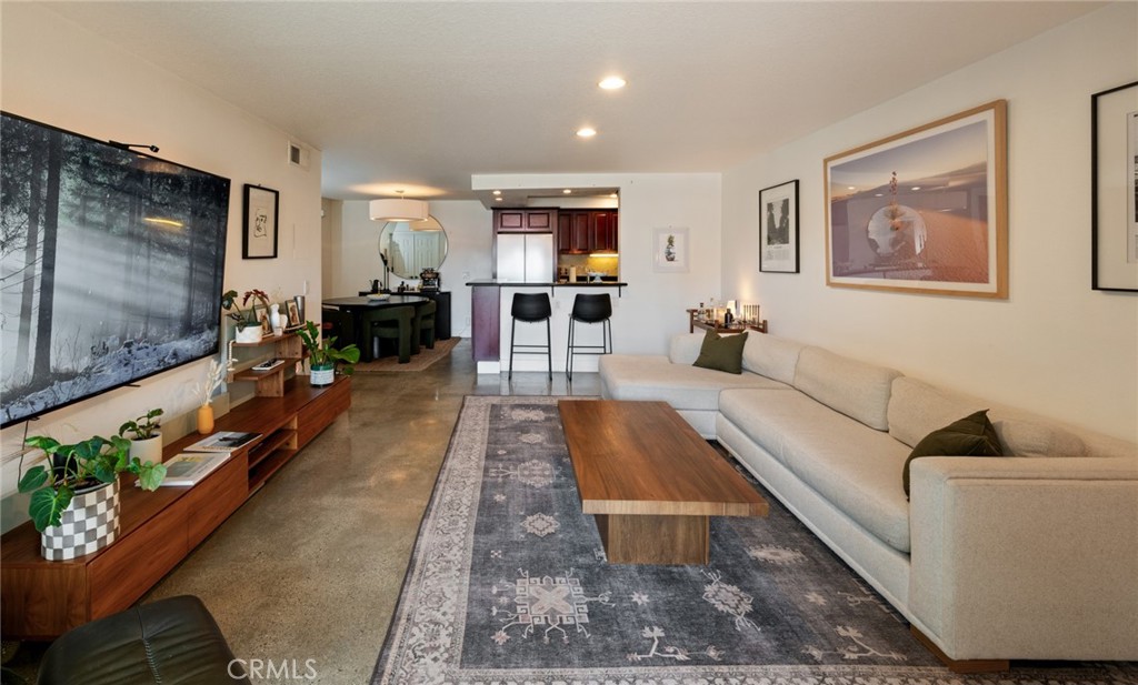 8512 Tuscany Avenue, Unit 222 Playa del Rey, CA 90293 - Photo 7 of 24 a living room with furniture and a flat screen tv