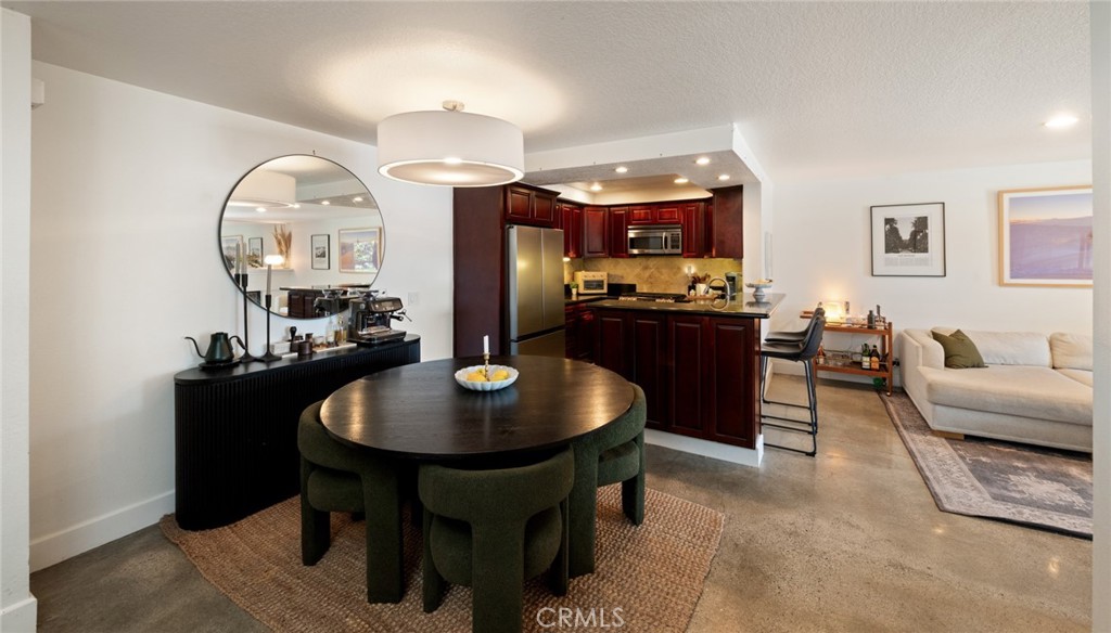 8512 Tuscany Avenue, Unit 222 Playa del Rey, CA 90293 - Photo 8 of 24 a living room with furniture a rug and kitchen view