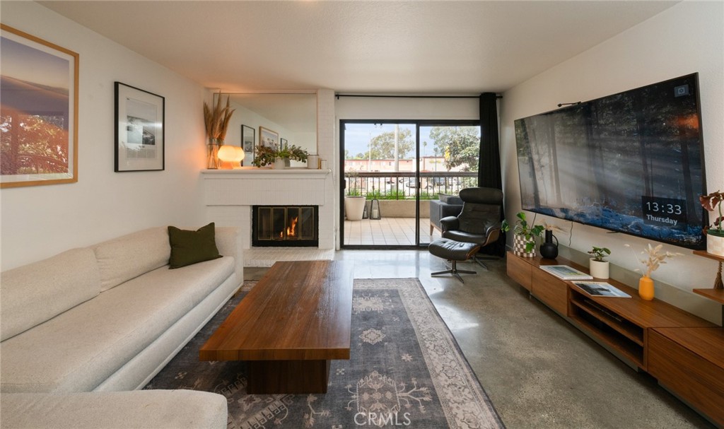 8512 Tuscany Avenue, Unit 222 Playa del Rey, CA 90293 - Photo 9 of 24 a living room with furniture and a flat screen tv