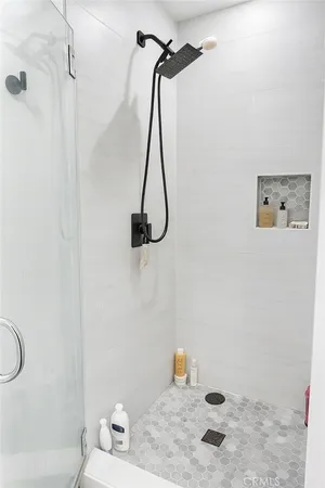 a bathroom with a shower and a shower head