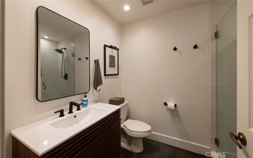 8512 Tuscany Avenue, Unit 222 Playa del Rey, CA 90293 - Photo 10 of 24 a bathroom with a sink toilet and mirror
