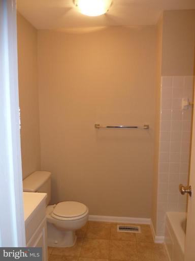 20 Ridgelawn Road, Unit B Reisterstown, MD 21136 - Photo 2 of 11 a white toilet sitting next to a shower