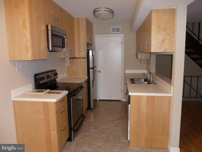 20 Ridgelawn Road, Unit B Reisterstown, MD 21136 - Photo 8 of 11 a kitchen with a refrigerator stove and microwave