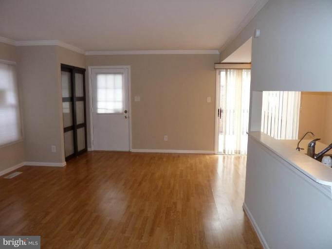 20 Ridgelawn Road, Unit B Reisterstown, MD 21136 - Photo 9 of 11 an empty room with wooden floor and windows