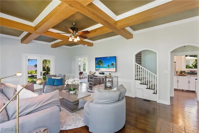 a living room with fireplace furniture and a wooden floor