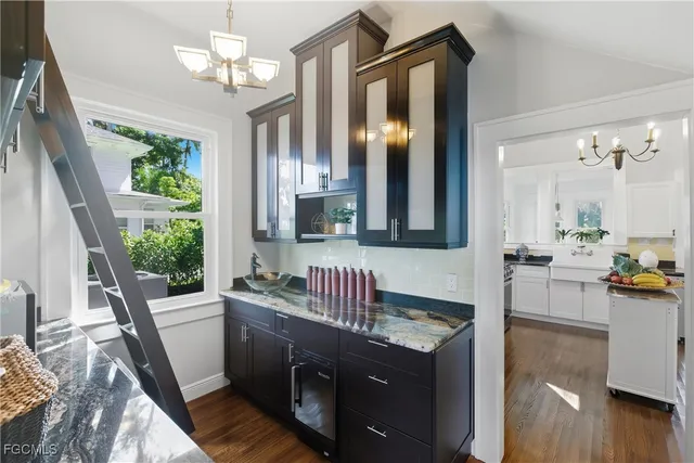 a kitchen with granite countertop a sink appliances and cabinets