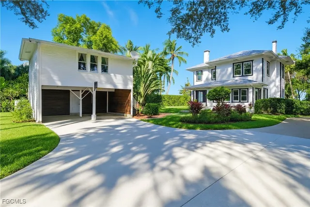 a front view of a house with a garden and plants