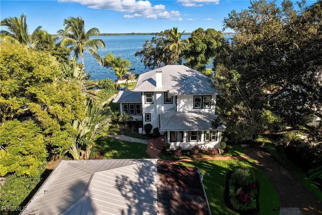a front view of a house with a yard basket ball court and outdoor seating