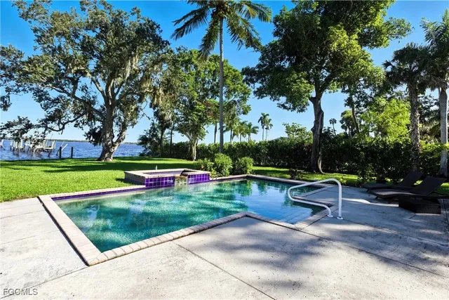 a view of backyard with swimming pool and outdoor seating