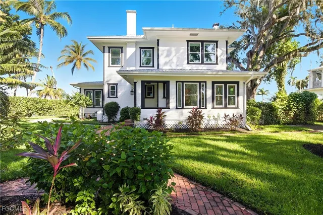 a front view of a house with swimming pool having outdoor seating