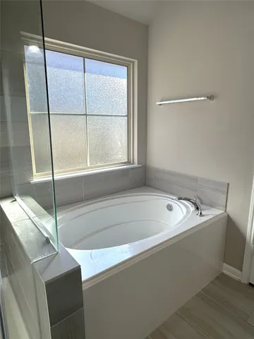 a bath tub sitting next to a window
