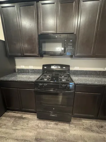 a stove top oven sitting inside of a kitchen