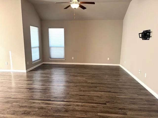 a view of room with window and wooden floor