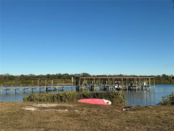 a view of a lake with houses in the back