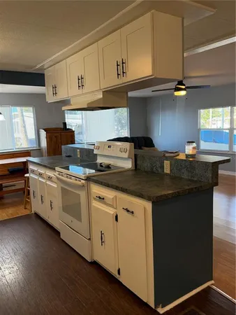 a kitchen with granite countertop a sink cabinets and stainless steel appliances