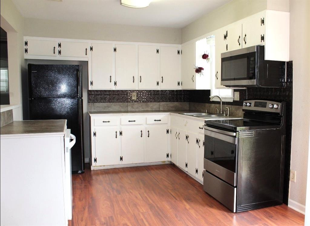100 Hickory Road Lone Oak, TX 75453 - Photo 11 of 30 a kitchen with granite countertop a stove and a microwave