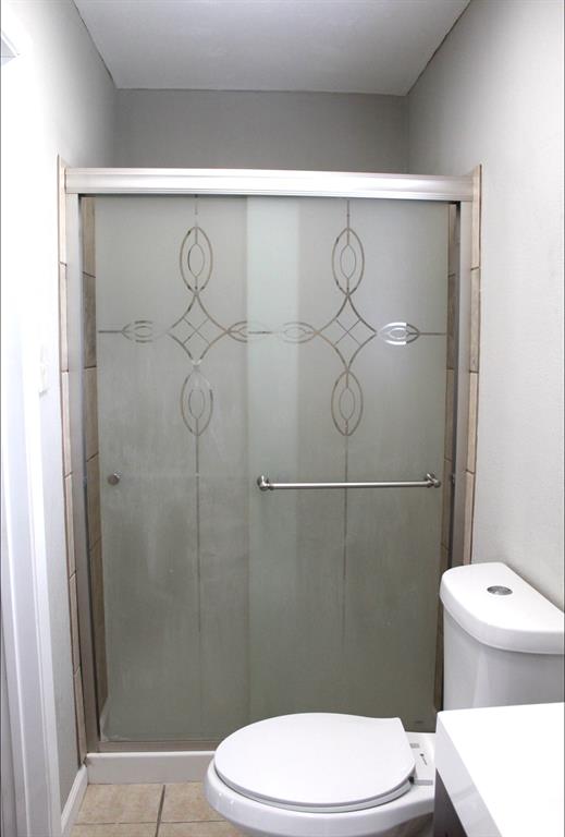 100 Hickory Road Lone Oak, TX 75453 - Photo 21 of 30 a white toilet sitting next to a bathroom shower