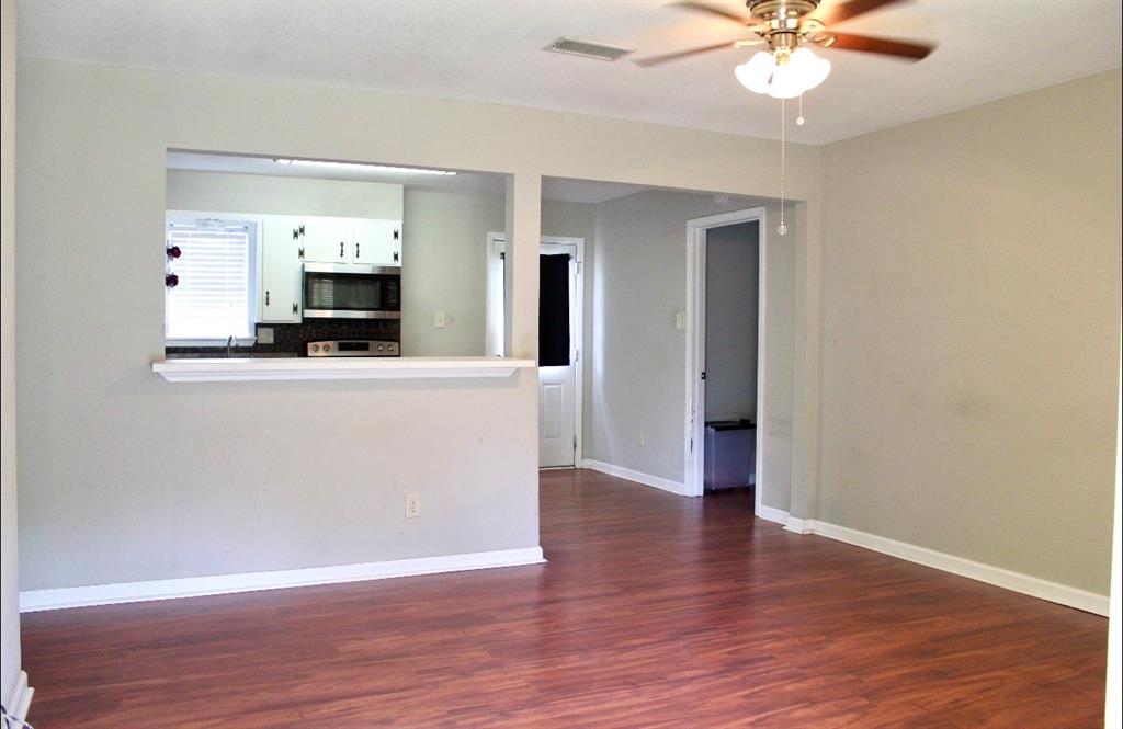 100 Hickory Road Lone Oak, TX 75453 - Photo 10 of 30 a view of a kitchen with wooden floor and a ceiling fan