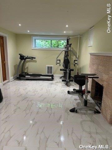 59 Radnor Road Great Neck, NY 11023 - Photo 12 of 15 a room with gym equipment and a large window