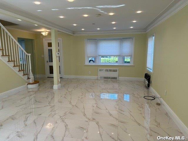 59 Radnor Road Great Neck, NY 11023 - Photo 4 of 15 a view of a hallway with a projector and furniture
