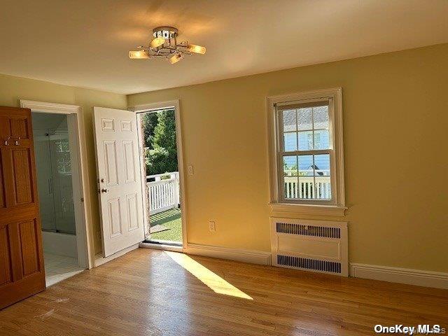 59 Radnor Road Great Neck, NY 11023 - Photo 9 of 15 wooden floor in an empty room with a window